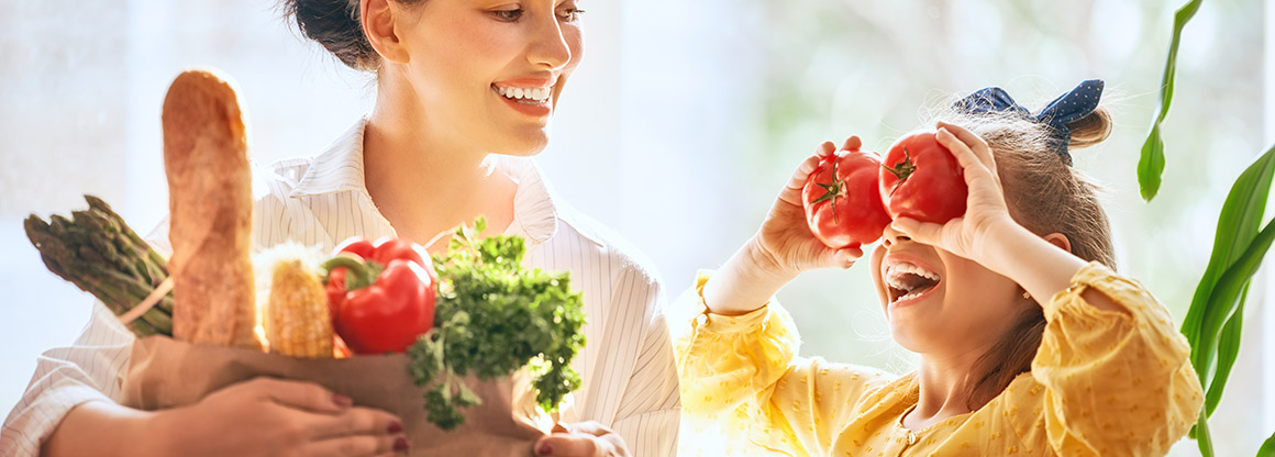 Kid and parent with vegetables 