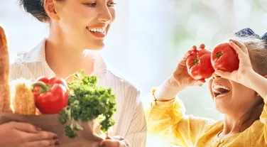 Kid and parent with vegetables 