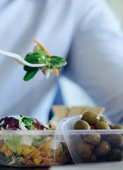 Person eating salad